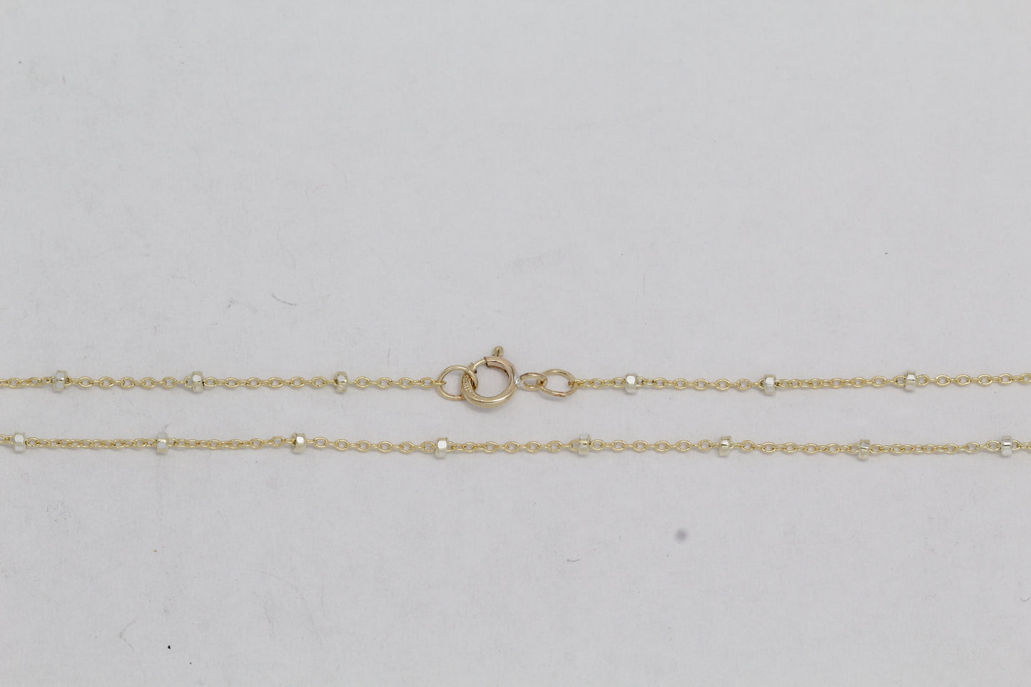2 Tone - Gold Filled & Sterling Silver, 1.0mm Width / Length, 18 Inch Regular Satellite Chain with 5.0mm Width / Length by 1.0mm Thick, Smooth Spring Ring Clasp. Quantity Per Pack: 1 Piece.
