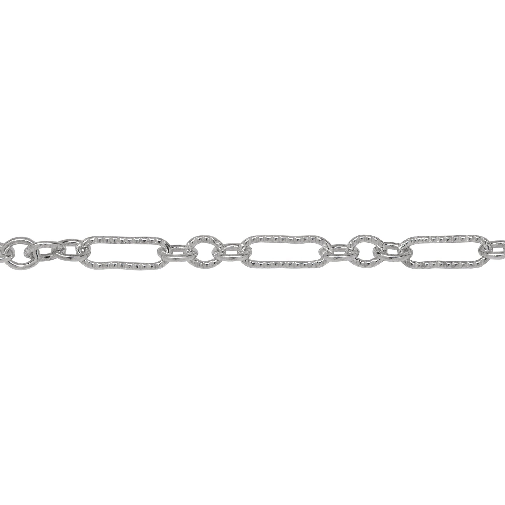 Chain by Foot. Sterling Silver One of 3.1mm Width by 9.4mm Length Corrugated Elongated Oval Link Followed by Three of 3.1mm Width by 4.0mm Length Smooth Oval Links with Middle Oval Link being Corrugated, Long and Short Chain. Price per: 1 Foot.