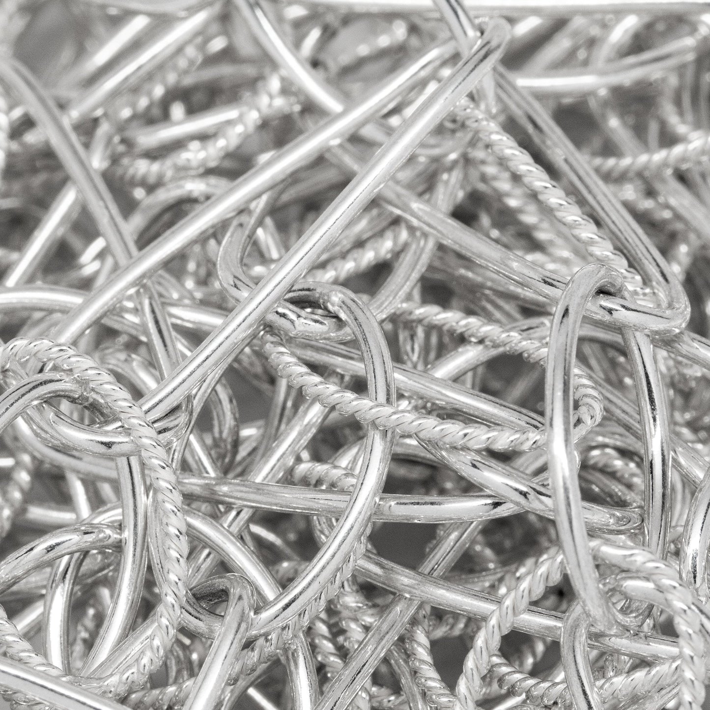 Sterling Silver 8.6mm Width by 27.8mm Length Twisted Rectangular Link Followed by 11.2mm Width by 16.8mm Length Smooth Oval Link With a 10.6mm Width by 16.4mm Length Twisted Wire Oval Link Hanging Off, Long and Short Chain. Price per: 1 Foot.