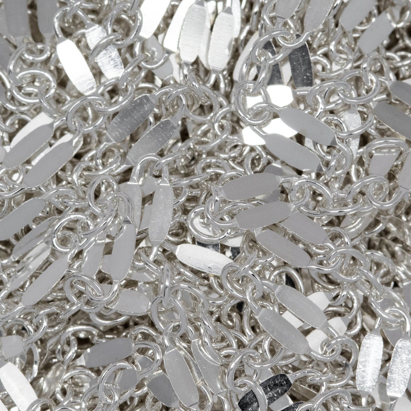 Sterling Silver 2.4mm Width by 5.1mm Length, Dapped Elongated Oval Link Followed by Three of 1.7mm width by 2.1mm length Smaller Oval Links, Long and Short Chain. Price per: 1 Foot.