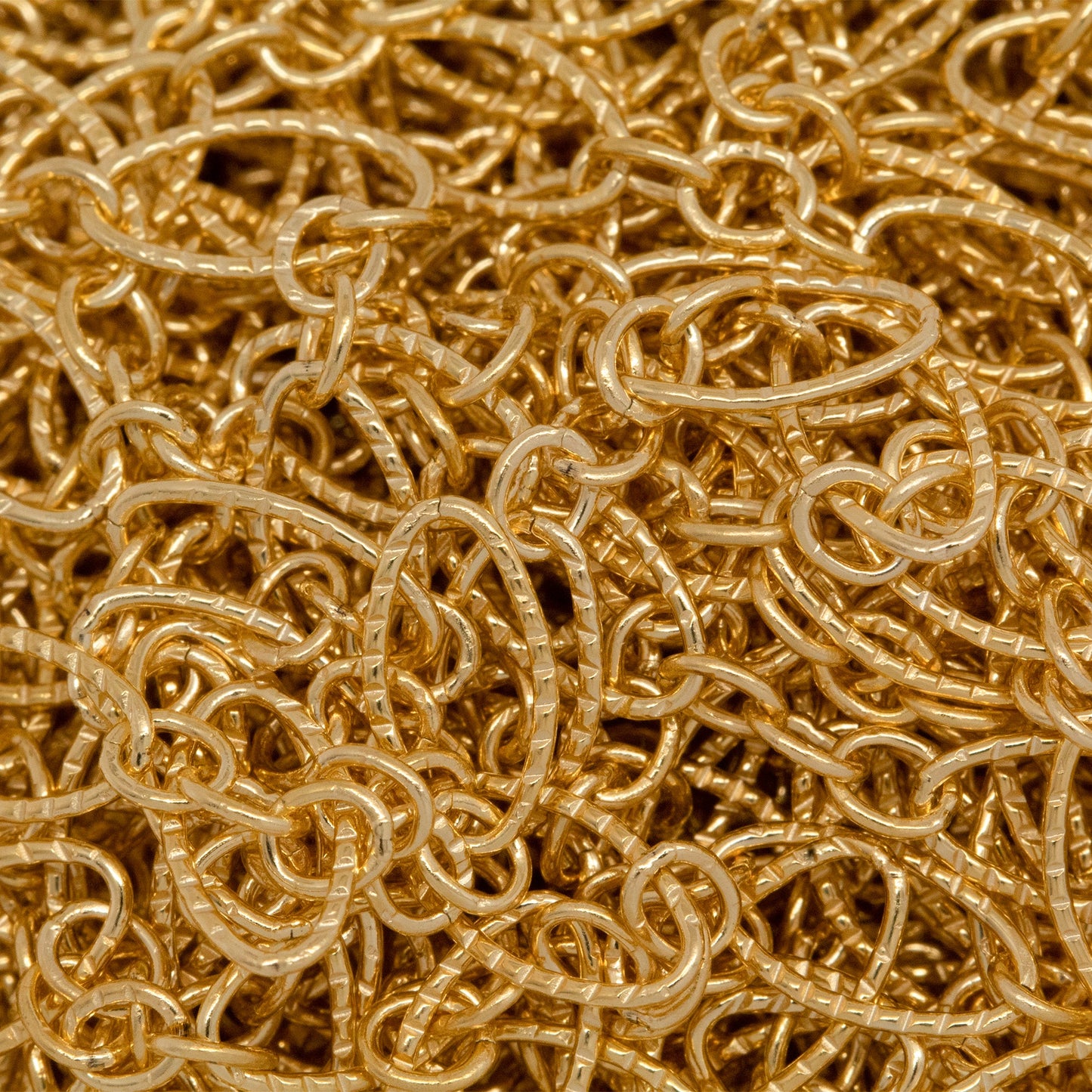 14kt Gold Filled Three of 2.4mm Width by 3.0mm Length Small Oval Links With Middle Small Oval Link being Corrugated One, Followed by 3.9mm Width by 7.8mm Length Large Corrugated Oval Link, Long and Short Chain. Price per: 1 Foot.