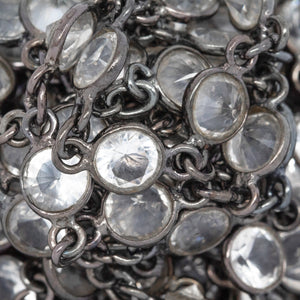 Sterling Silver Oxidized 5.7mm Width / Length Crystal Round Bezel Set Connected by 2.87mm Width / Length Smooth Circle On Each Side, Followed by 2.8mm Width by 3.8mm Length Smooth Oval Link, Bezel Set Chain. Price per: 1 Inch.