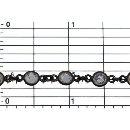 Sterling Silver Oxidized 5.7mm Width / Length Crystal Round Bezel Set Connected by 2.87mm Width / Length Smooth Circle On Each Side, Followed by 2.8mm Width by 3.8mm Length Smooth Oval Link, Bezel Set Chain. Price per: 1 Inch.